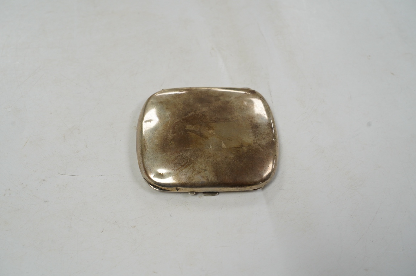 A 1920's/1930's German? 935 standard white metal cigarette case, with interior cover enamelled with a reclining nude (enamelled damaged and restored), 91mm, gross weight 6.1oz. Condition - poor